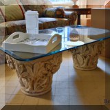 F25. Glass top beveled edge coffee table with concrete pedestals base. 18”h x 50”w x 30”d 